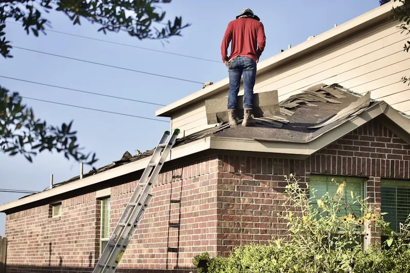 Professional roofer working on a residential roof in San Bruno